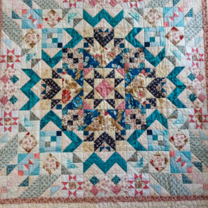 California quilt in pinks and blues.